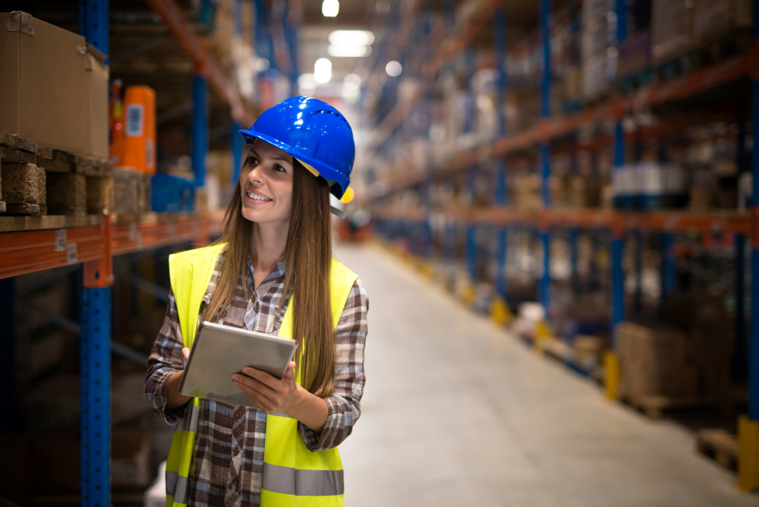 Female,Warehouse,Worker,With,Tablet,Counting,Products,On,Shelves,In